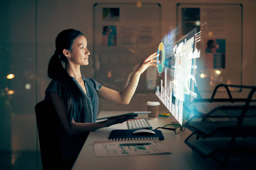 A woman works on a futuristic digital interface, illustrating steps in mobile app development.